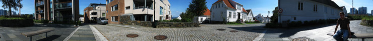 360 degrees photo of the city edge of old Stavanger, Aleksander is sitting on the bench.